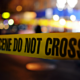 photo of crime scene tape and lights at night