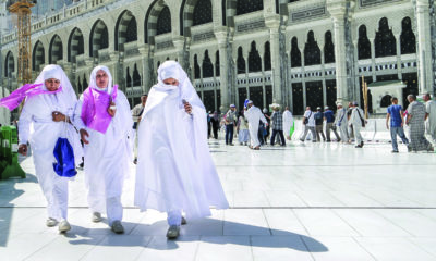 Women in Saudi Arabia walk through city.
