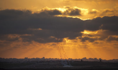 Palestinian protesters run from gas fired by Israeli troops in the Gaza Strip Border.
