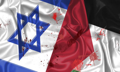 Flags of Israel and Palestine spattered with blood