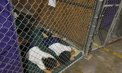 Two female detainees sleep in a holding cell,