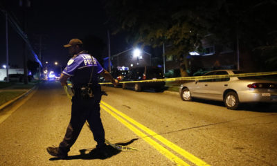 Photo of a police spreading crime tape