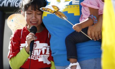 AP photo of child crying as she talks about being separated from her father