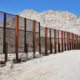Photo of steel fence protecting the border between Mexico and the United States at the Tinajas Altas Mountains in Arizona.
