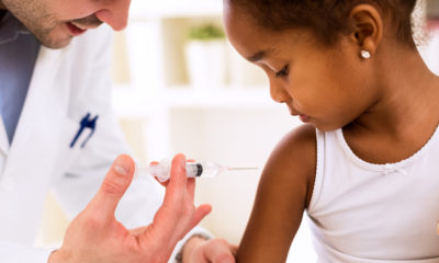 Photo of a young girl receiving a vaccine shot