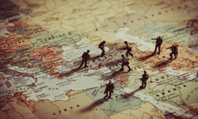 Photo Illustration of Toy Soldiers on a map of the Middle East.