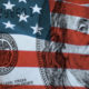 Federal Reserve Bank symbolized by American flag and Ben Franklin's image on a $100 bill