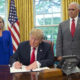 Photo of President Donald Trump signing order ending the separation of detained immigrant parents and children