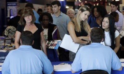 Job applicants talk with hiring rerpresentatives