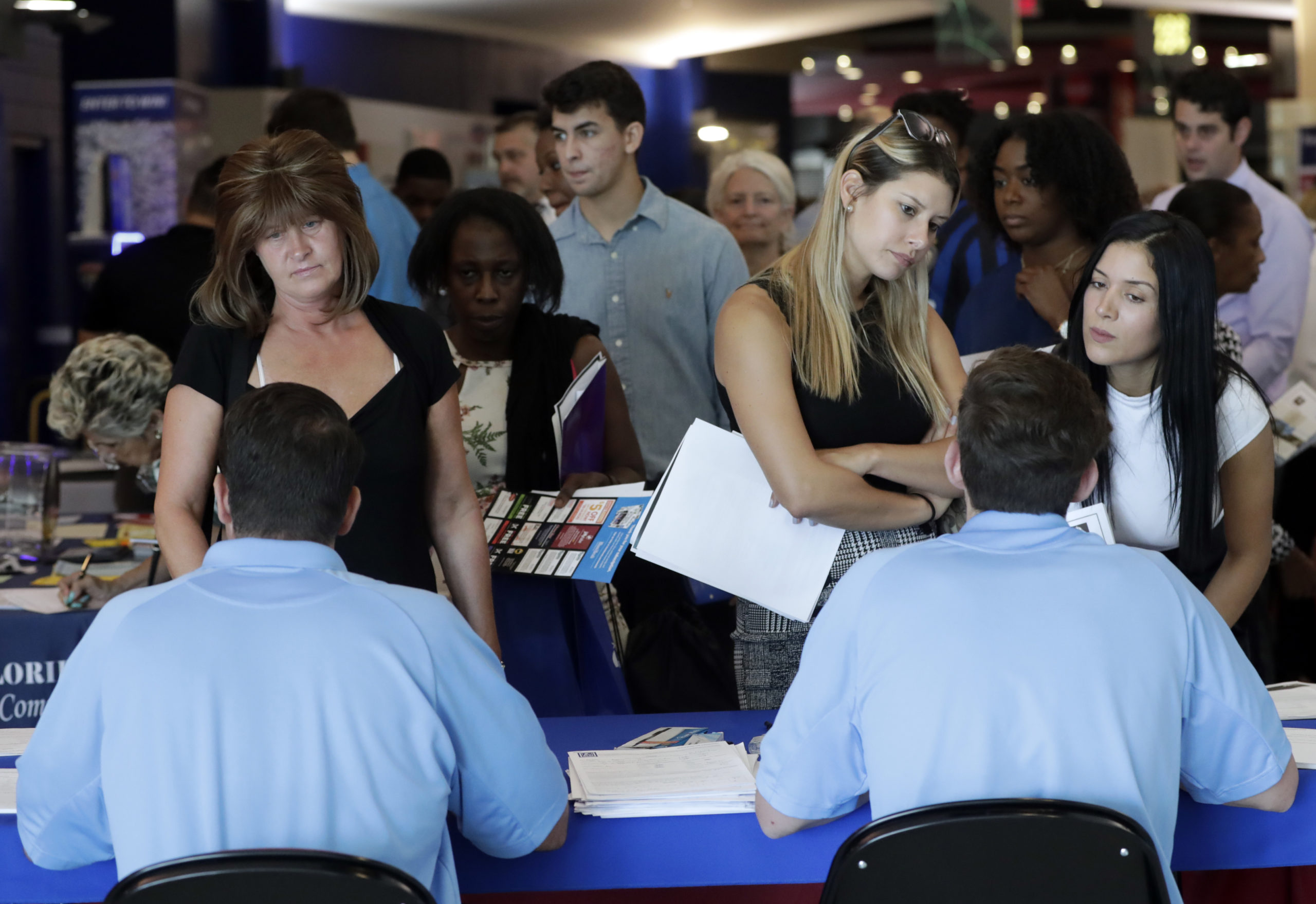 Job applicants talk with hiring rerpresentatives