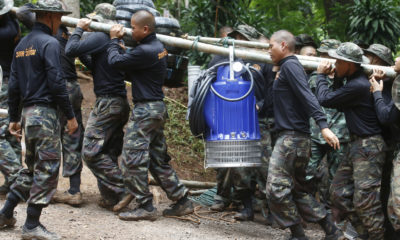 Photo of soldiers carrying a pump to drain Thai cave