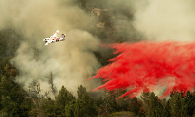 Photo of air tanker dropping retardant on the Ferguson Fire
