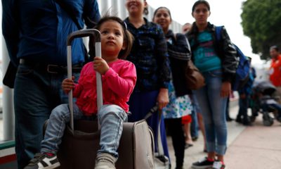 Photo of people waiting to cross into the U.S. to begin the process of applying for asylum