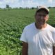Photo of Farmer Michael Slattery standing in front of his soybean field