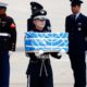 Photo of soldier carrying a casket containing a remain of a US soldier