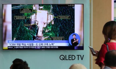 Photo of TV screen showing a satellite image of North Korea's Sohae launch site