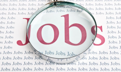 Illustration of the word "Jobs" under a magnifying glass