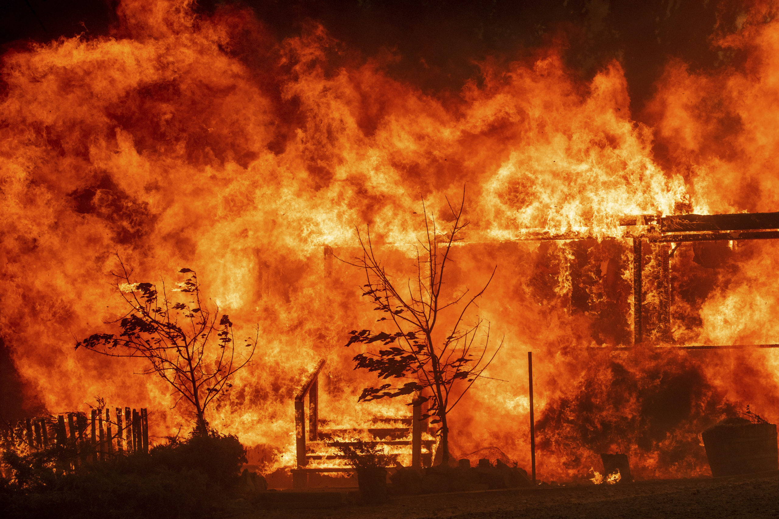 Photo of the River Fire consuming a home