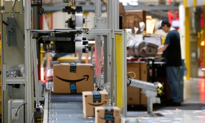 Photo of Amazon packages passing through a scanner at an Amazon fulfillment center in Baltimore