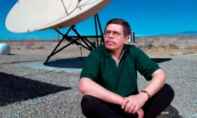 File Photo of Art Bell siting near a satellite in Nevada