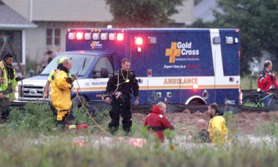 Photo of emergency responders rescuing boy that got sucked into a storm sewer