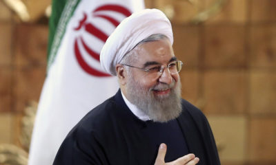 Iran President Hassan Rouhani in front of national flag