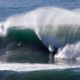 Photo of two surfers sharing a wave in Half Moon Bay, California