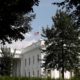Photo of the American flag flying half-staff at the White House in Washington
