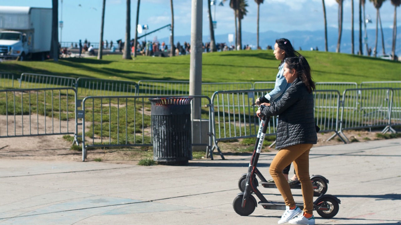 Photo of two girls riding motorized scooters in Venice