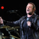 U2 lead singer Bono performing on stage