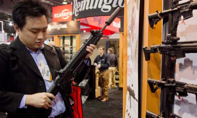 Photo of accessories manufacturer Kevin Kao examining a military grade Remington Adaptive Combat Rifle
