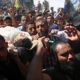 Photo of mourners chanting while carrying the body of Ahamd Omar