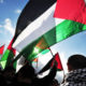 Palestinians march with flags