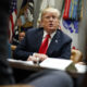 Photo of President Trump sitting behind a desk