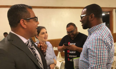 Miguel Arias and Tate Hill talk with voters after a District 3 candidate forum.