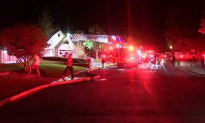 Photo of firefighters at burned house