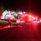 Photo of firefighters at burned house