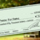 Photo Illustration of a check representing financial support for Yes on P committee