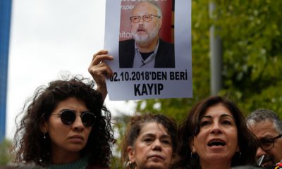 Photo of activists protesting with photos of missing Saudi journalist Jamal Khashoggi