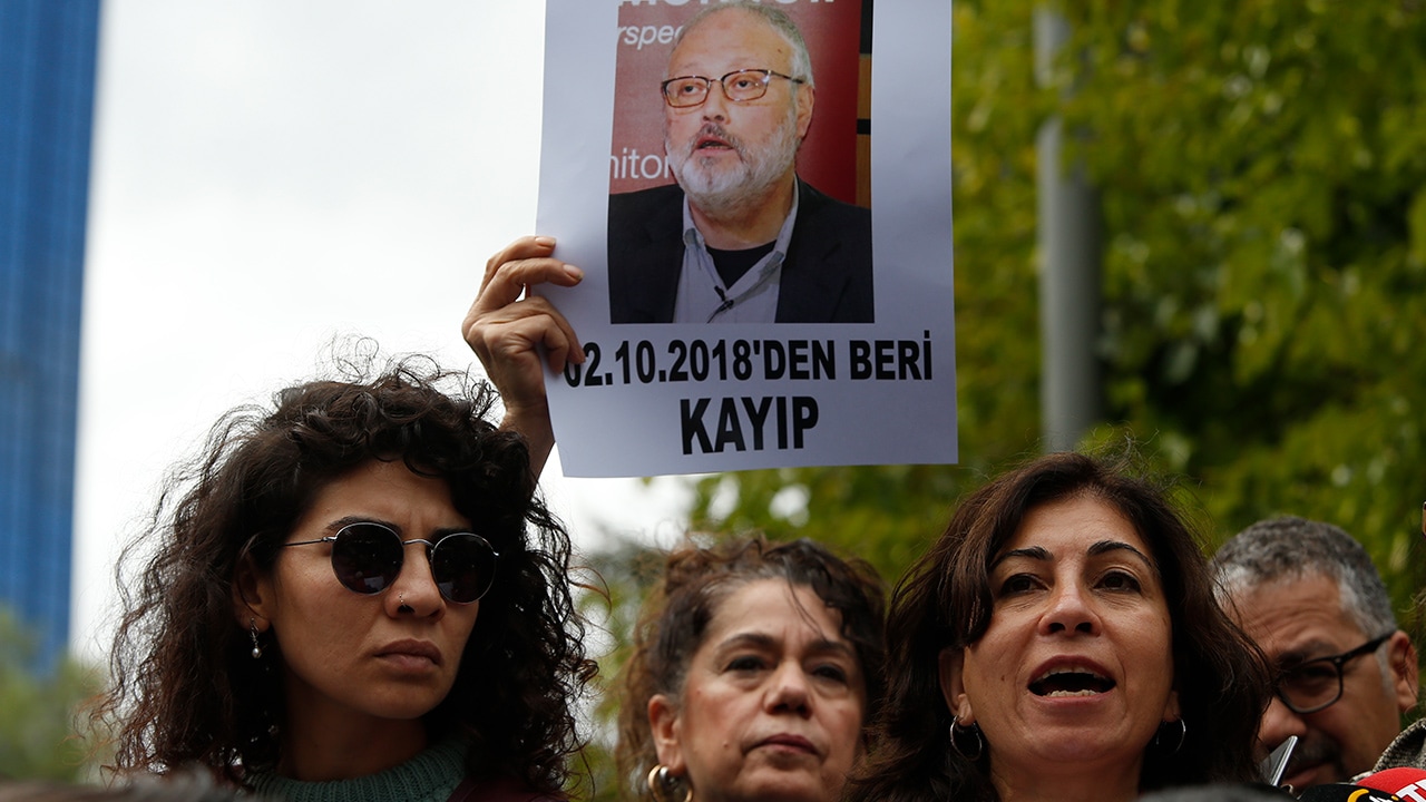 Photo of activists protesting with photos of missing Saudi journalist Jamal Khashoggi
