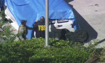 Photo of agents covering a van