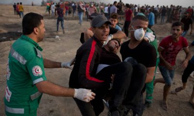 Photo of Palestinians evacuating a wounded protester