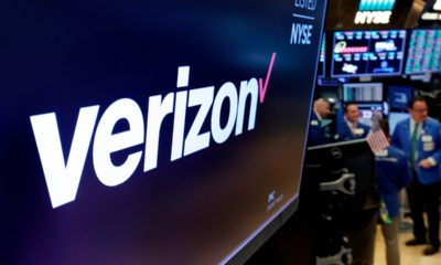 Photo of the logo for Verizon above a trading post on the floor of the New York Stock Exchange