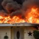 Photo of a home burning in Paradise, California.