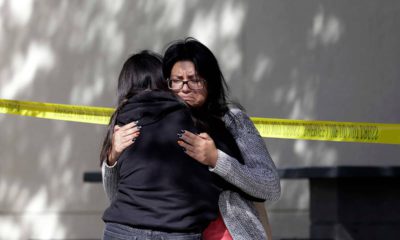 Photo of mourners embracing outside the Thousand Oaks Teen Center