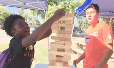 Photo of two teens playing giant Jenga in a Fresno park