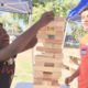 Photo of two teens playing giant Jenga in a Fresno park