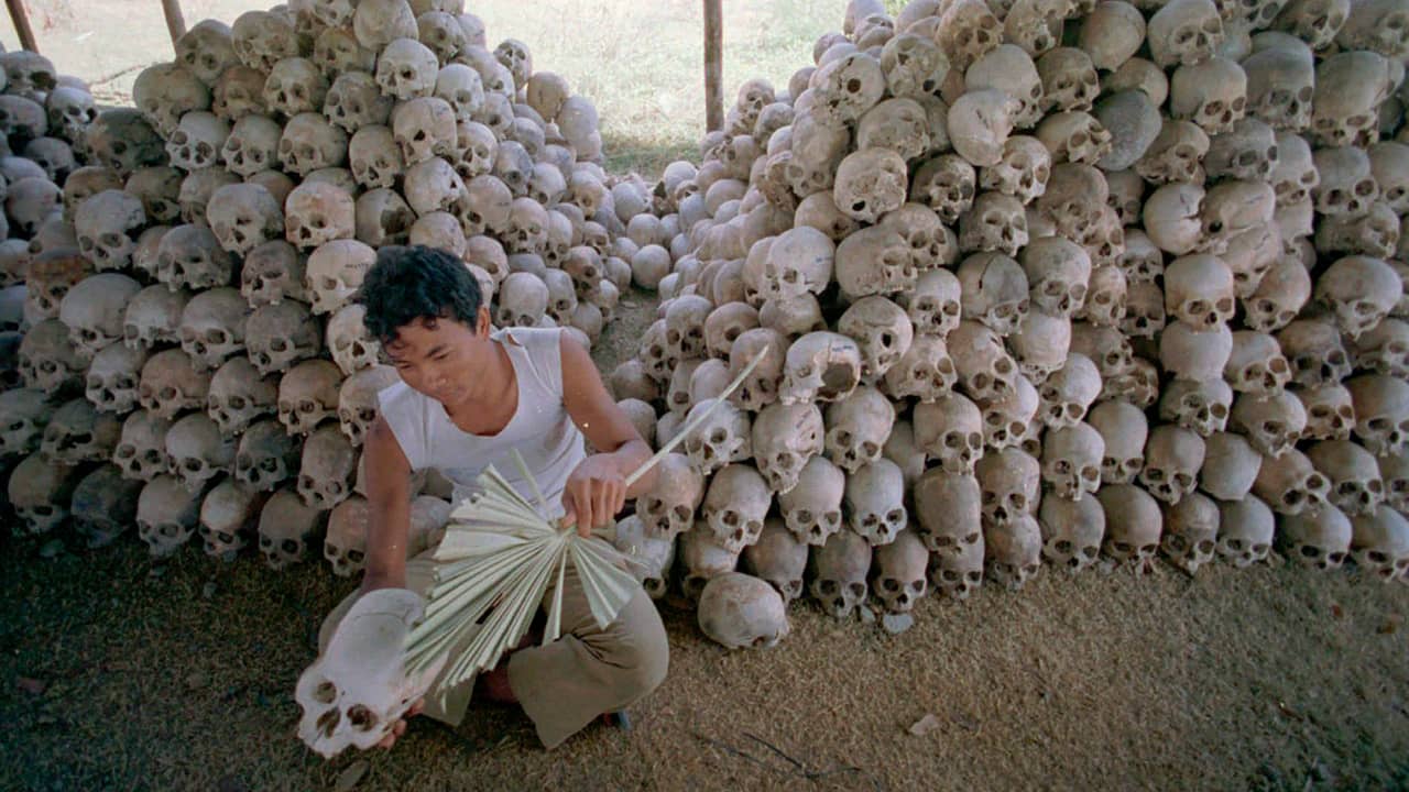 Photo of a man cleaning skulls