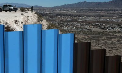 Photo of border fence and border patrol agent in New Mexico