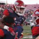 Photo of Fresno State defensive back Anthoula Kelly holding up game MVP running back Ronnie Rivers